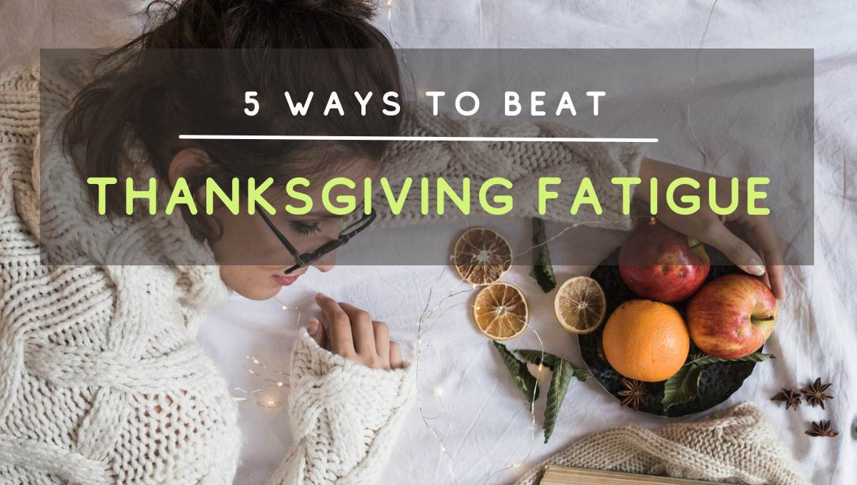 Woman resting on a bed beside dried oranges and fruit, with a text overlay reading ā5 Ways to Beat Thanksgiving Fatigue.ā