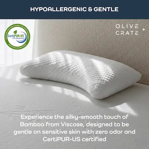 White pillow on a bed with 'Olive and Crate' branding and CertiPUR-US certification logo.