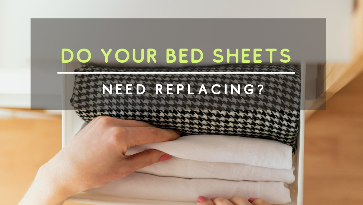 A person organizing folded bed sheets in a drawer with an overlaid headline that reads “Do Your Bed Sheets Need Replacing?”