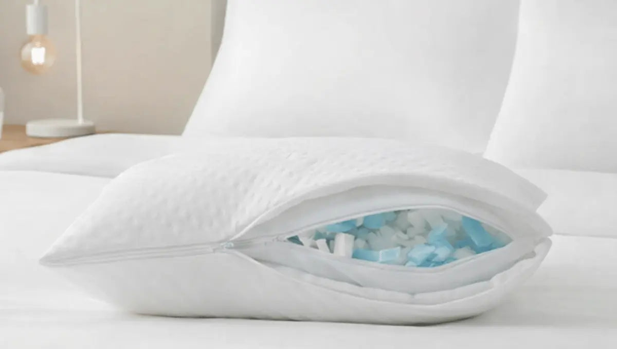 Adjustable pillow with unzipped cover showing removable foam fill on a white bed.