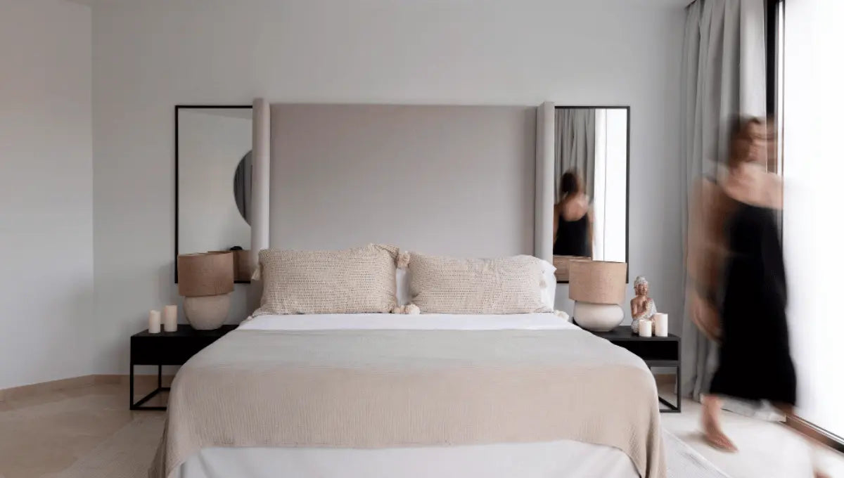Calm, balanced bedroom showing how to feng shui your bedroom with a centered bed, solid headboard, symmetrical nightstands, soft lighting, and minimal decor.