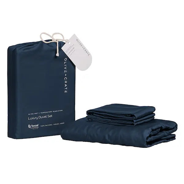 Dark navy blue duvet set with packaging and tag on a white background. 